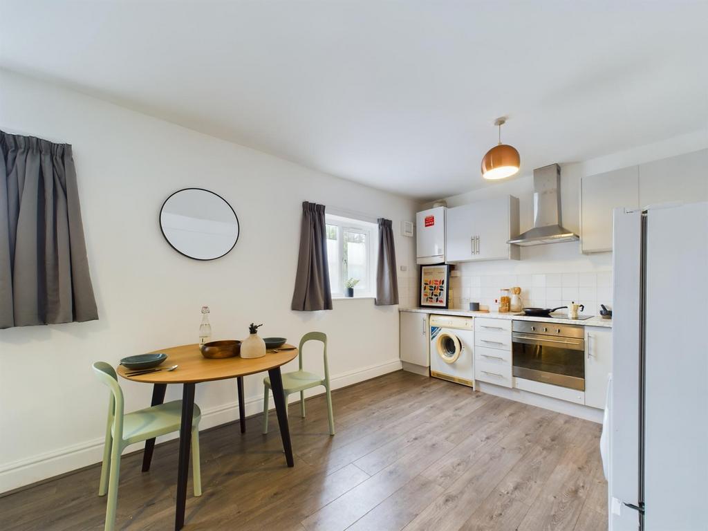 A bright and inviting kitchenette featuring mod...