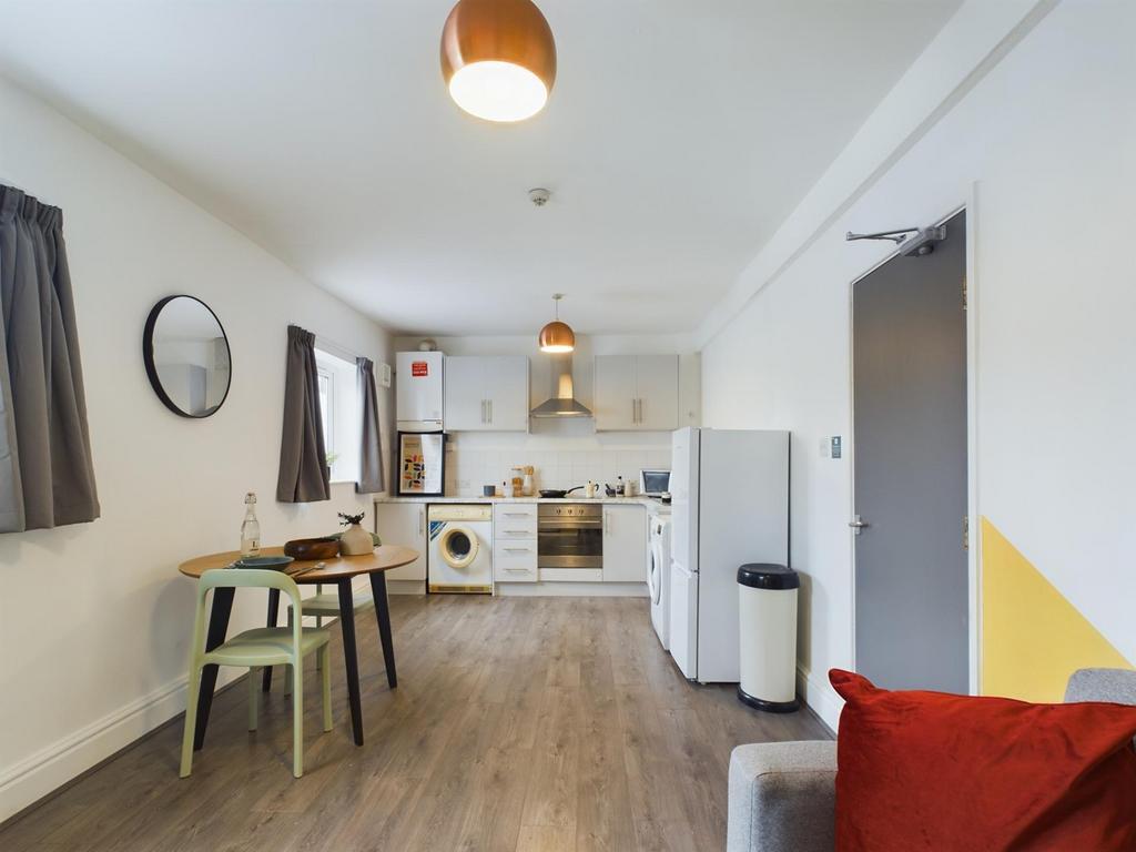A bright and inviting kitchenette with modern a...
