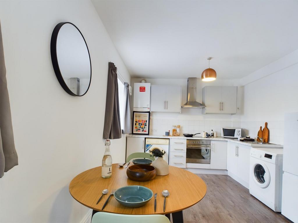 A bright and tidy kitchenette featuring modern ...