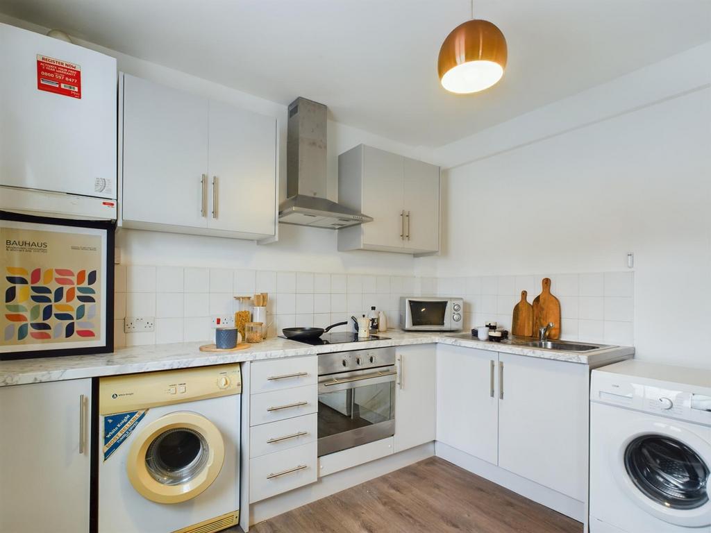 A modern and tidy kitchenette equipped with ess...