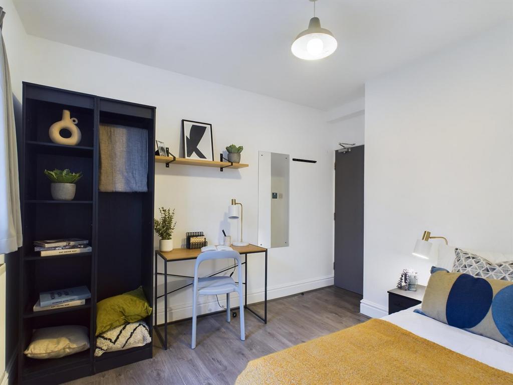 A bright and inviting double bedroom featuring ...