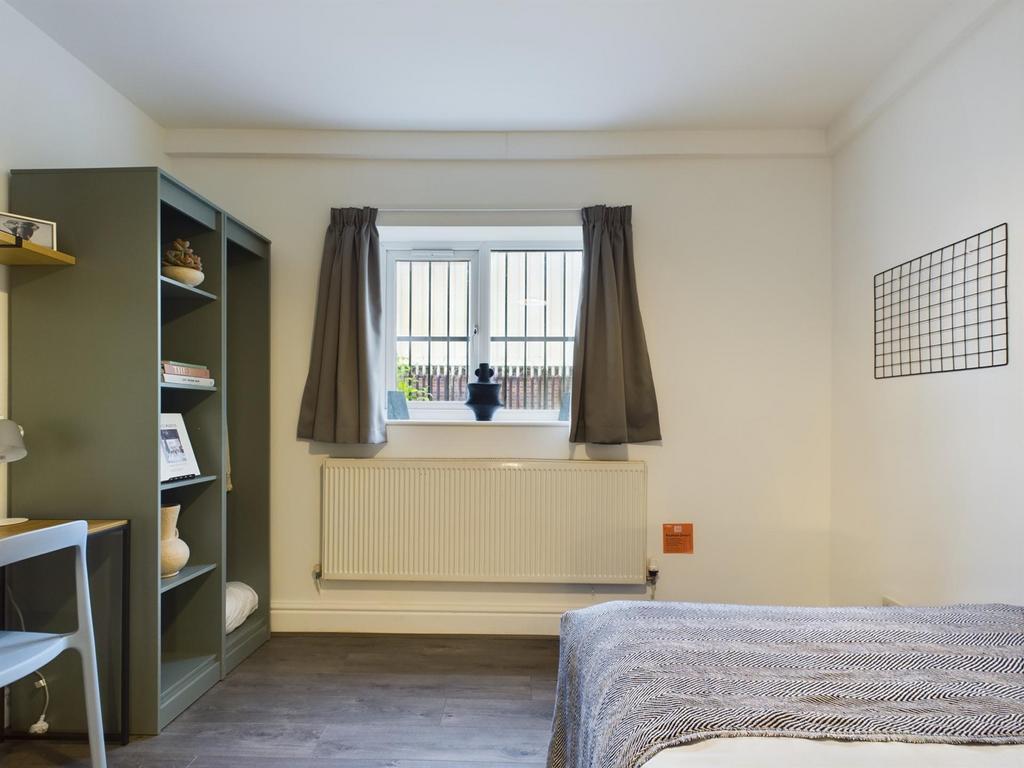 A bright and inviting double bedroom with moder...