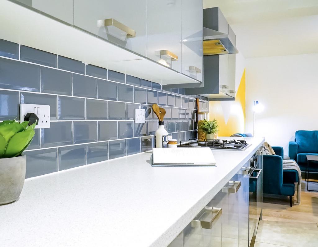 A modern kitchenette with sleek cabinetry and a...