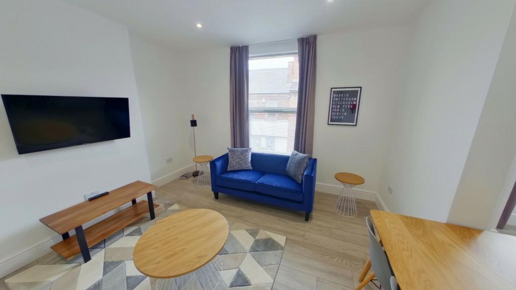 A bright and inviting large modern living room,...