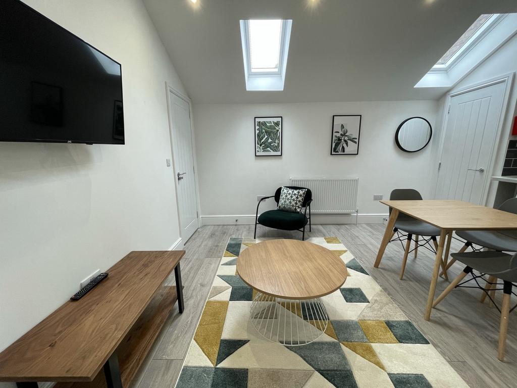 A bright and stylish large modern living room p...