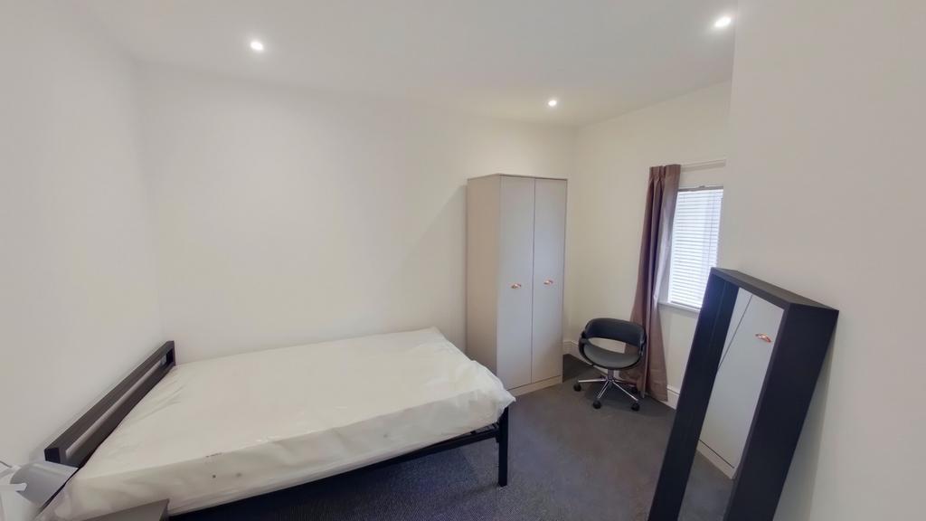A bright and inviting double bedroom with ample...