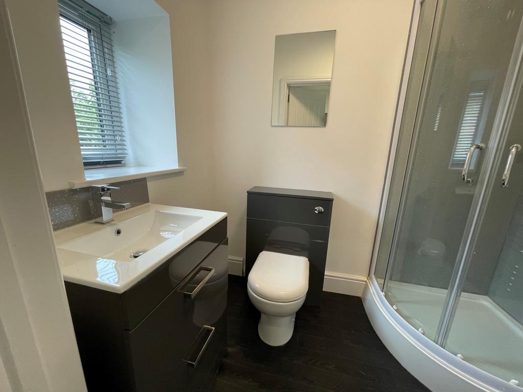 A modern and immaculate bathroom featuring a sl...