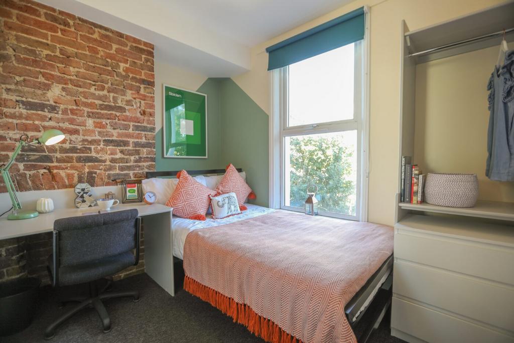 A spacious and stylish bedroom featuring an exp...