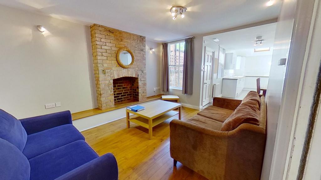 Bright, modern living room with exposed brick f...