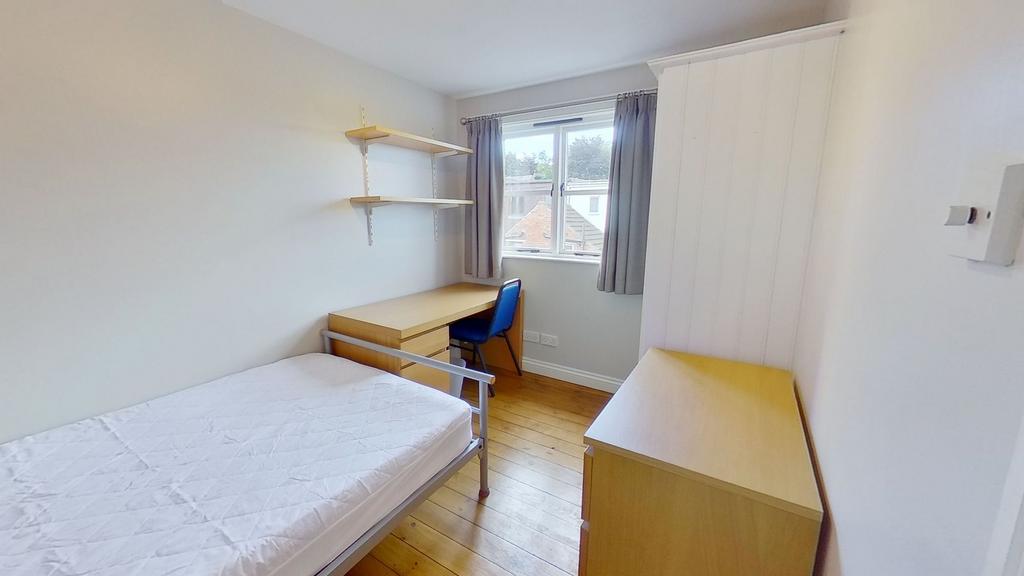 Bright, simply furnished single bedroom with a ...