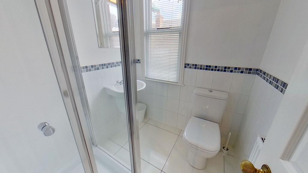 Bright, modern bathroom with white tiles, a wal...