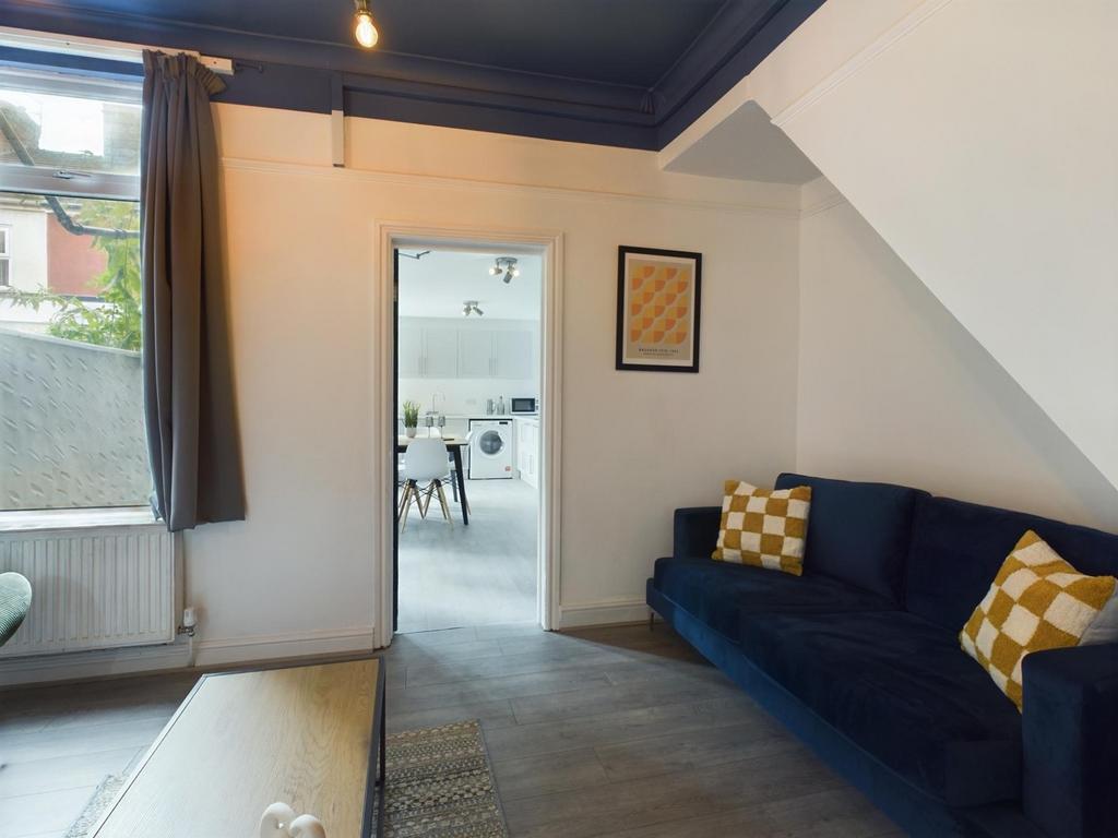 A bright and inviting living room featuring a c...
