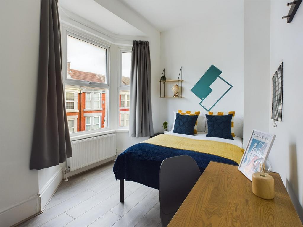 A bright and inviting double bedroom featuring ...