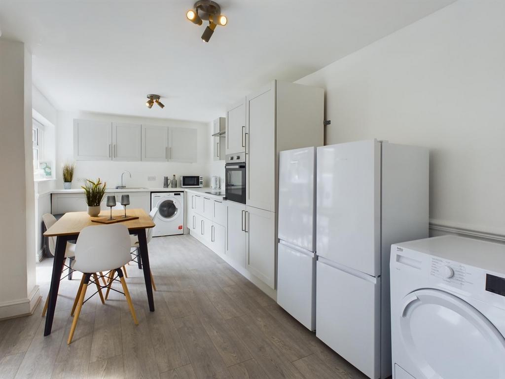 A bright and modern kitchen with ample space, p...