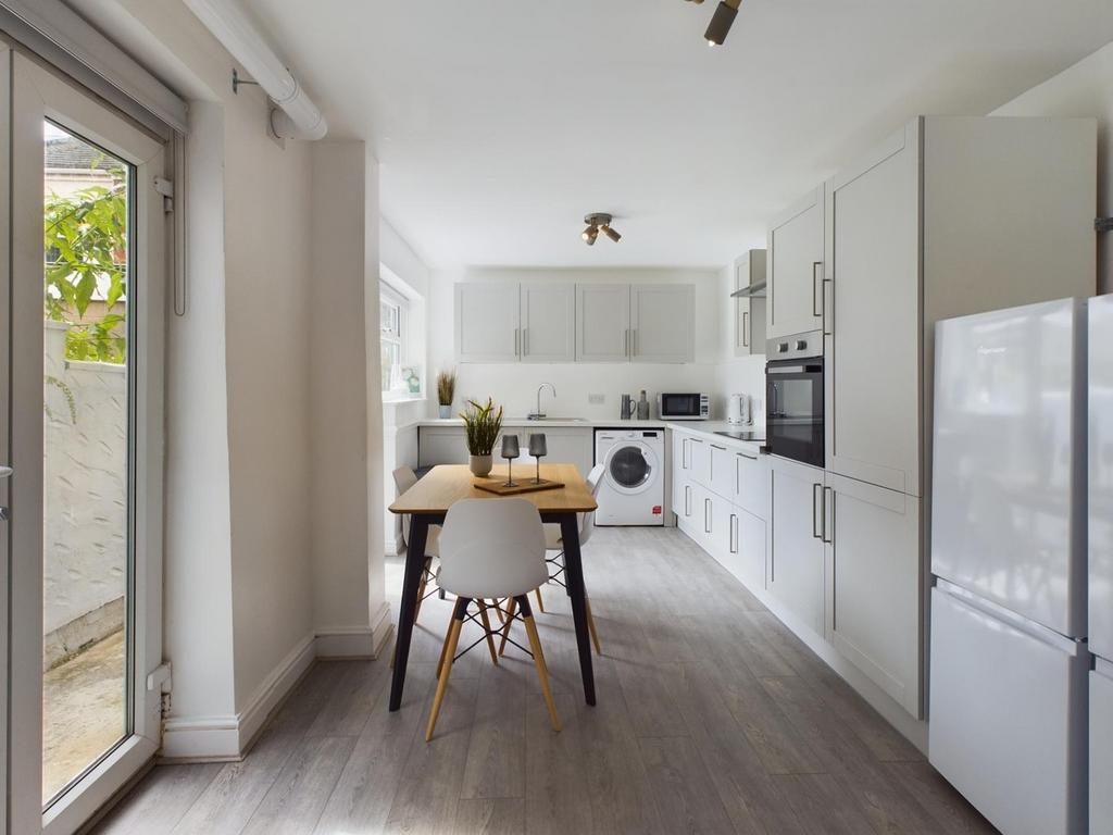 A bright and modern kitchen equipped with essen...