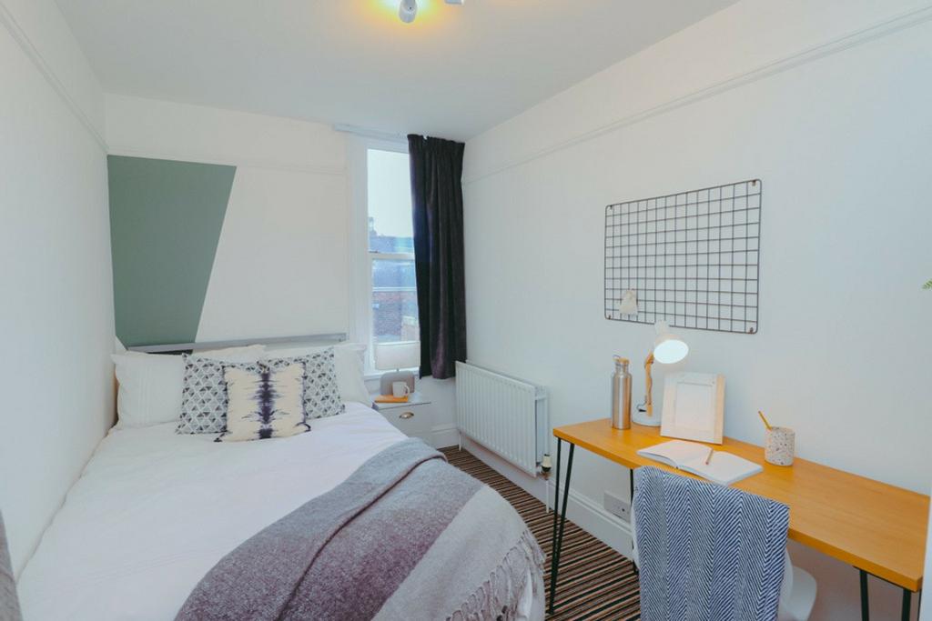 A bright and inviting double bedroom featuring ...