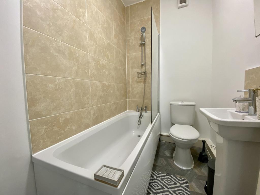 A clean and modern bathroom featuring a stylish...