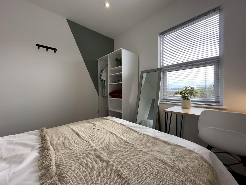 A bright and inviting double bedroom featuring ...