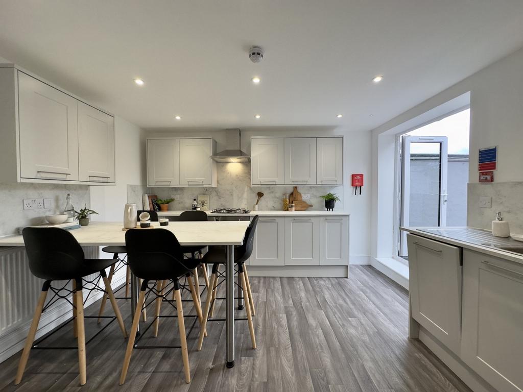 A modern and spacious kitchen with ample natura...