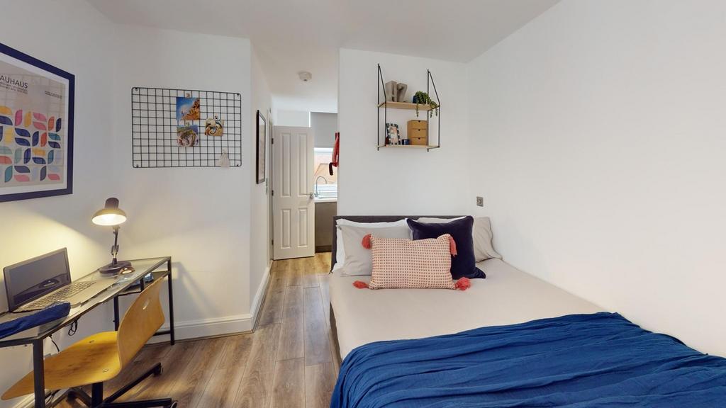 A bright and inviting double bedroom featuring ...
