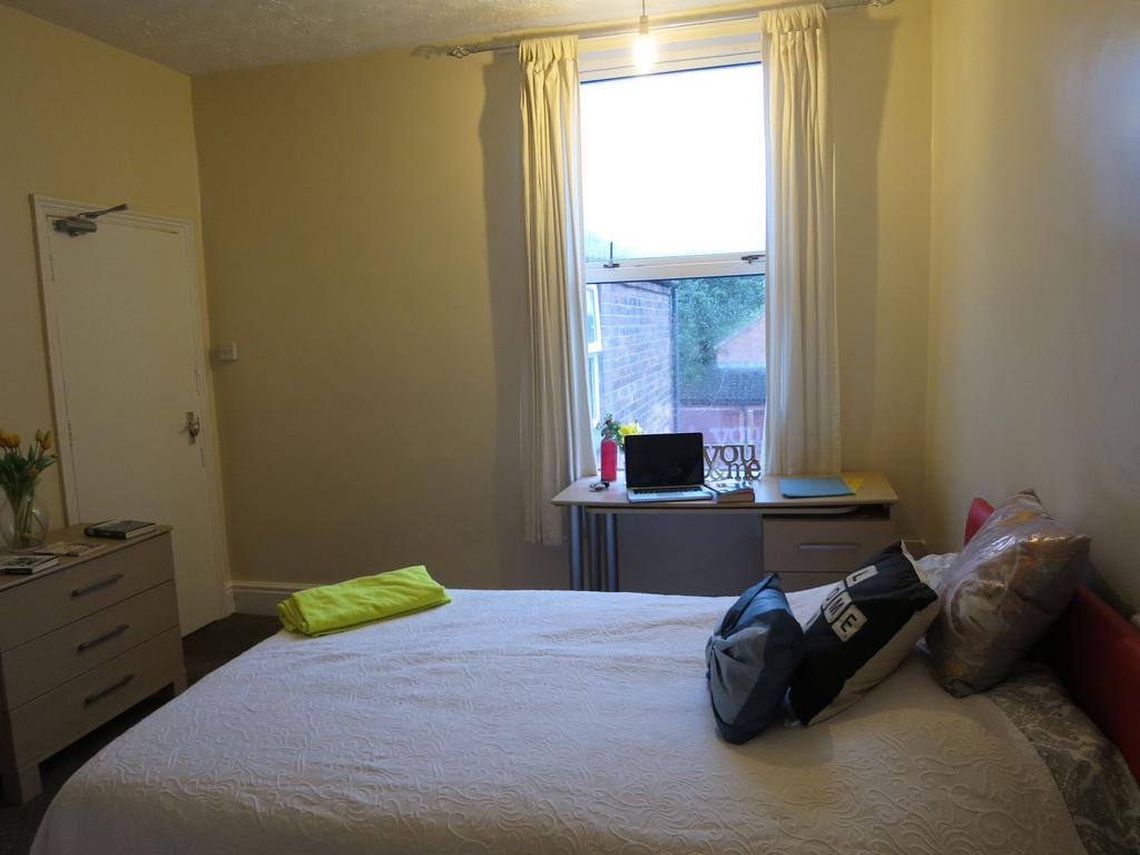 Bright, tidy bedroom with a double bed, desk by...