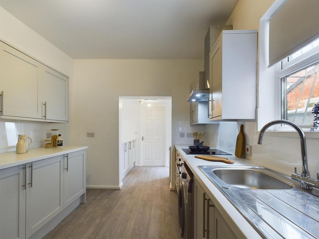 Modern kitchen featuring sleek cabinetry, ample...
