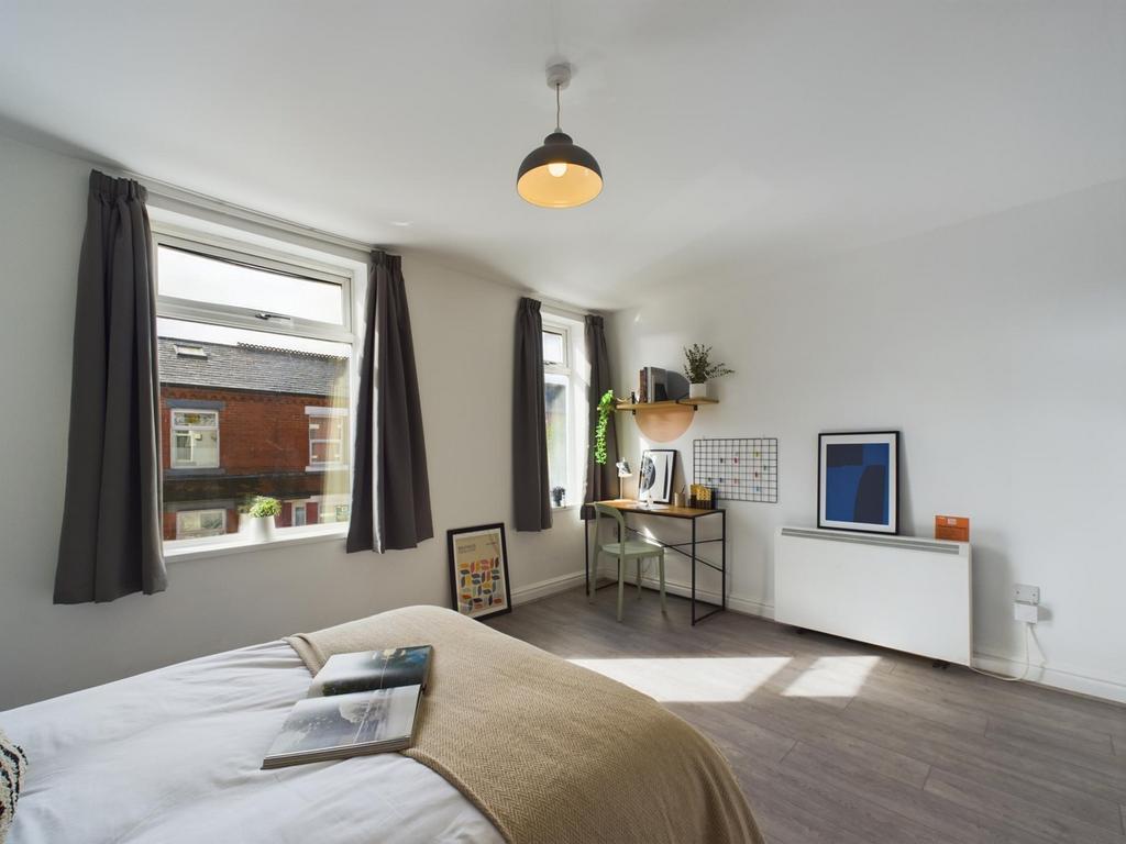 Bright and inviting double bedroom featuring la...