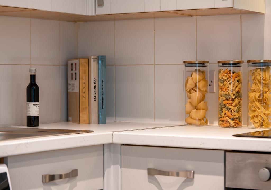 A bright and tidy kitchenette featuring organiz...