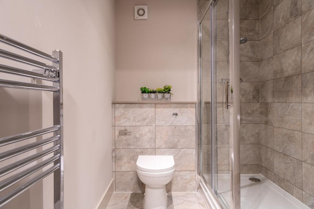 A modern bathroom featuring a shower enclosure ...