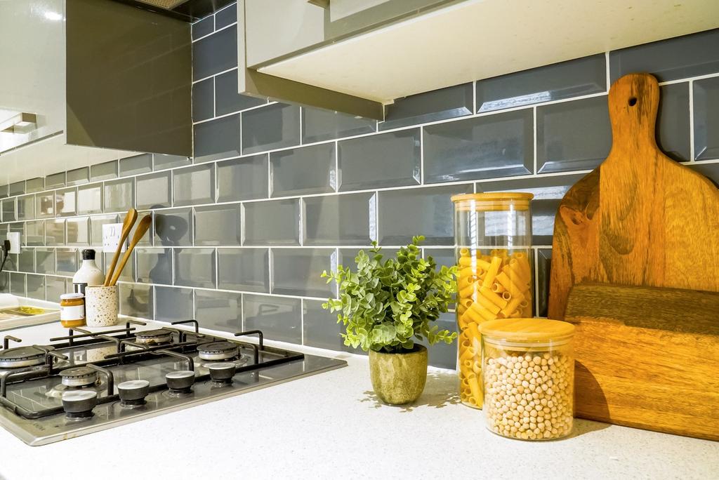 A modern kitchen featuring stylish backsplash t...