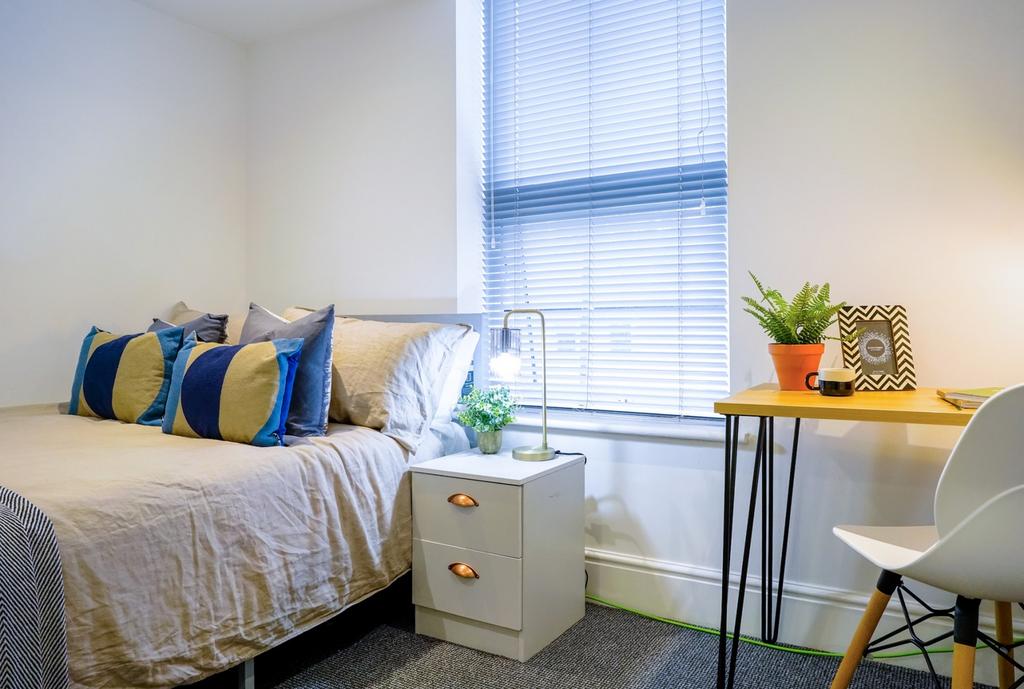 A bright and inviting double bedroom featuring ...