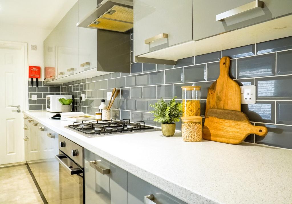 A modern and tidy kitchen with sleek cabinetry ...