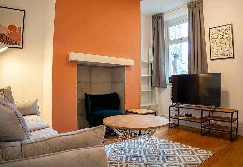 A bright and inviting living room featuring com...