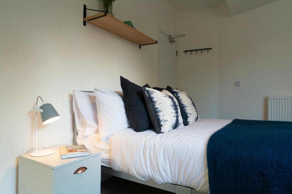A bright, well-maintained bedroom featuring a c...