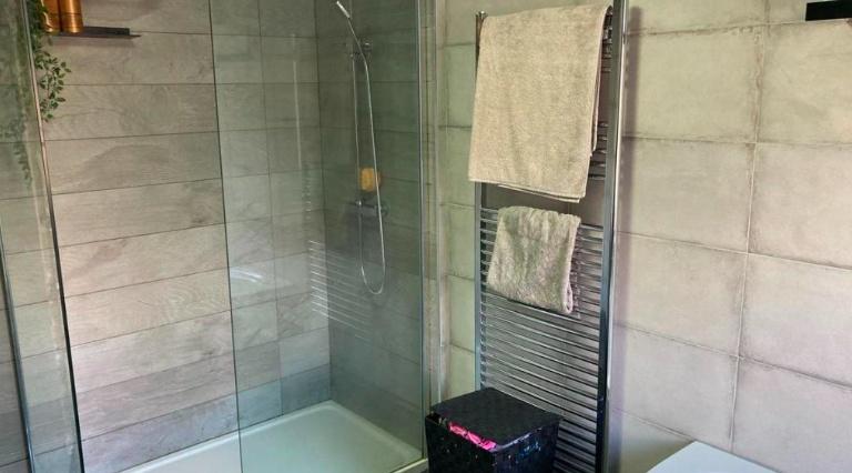 A clean and bright bathroom with a modern showe...