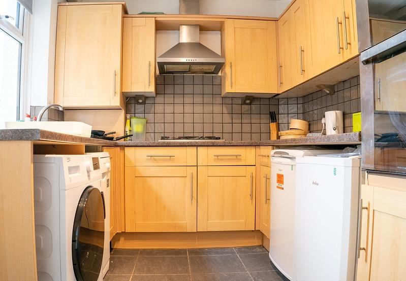 A well-maintained kitchen featuring wooden cabi...