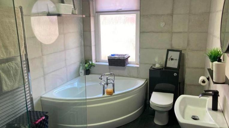 A clean and modern bathroom featuring a large b...