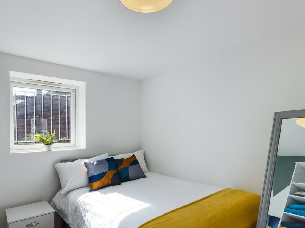 A bright and inviting double bedroom featuring ...