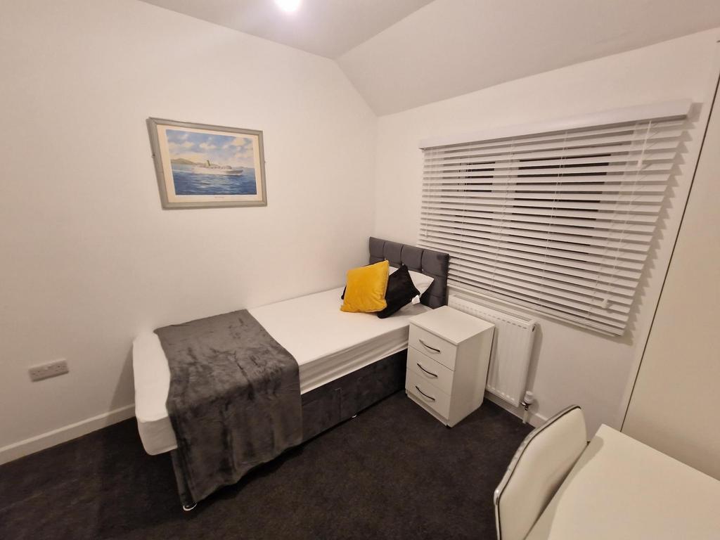 Neat, modern single bedroom with a comfortable ...