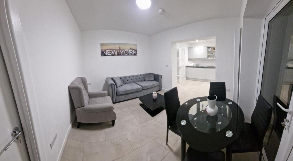 Bright, modern living area with a comfy upholst...