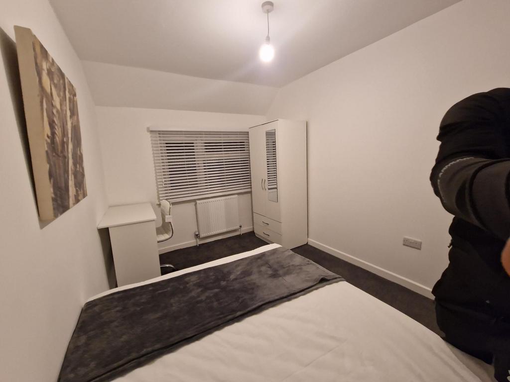 Bright, simply furnished double bedroom with a ...