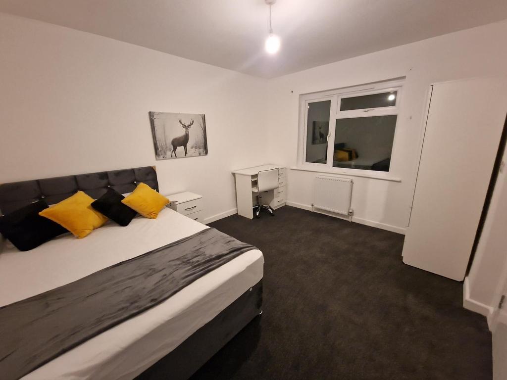 Bright, freshly redecorated bedroom with a comf...