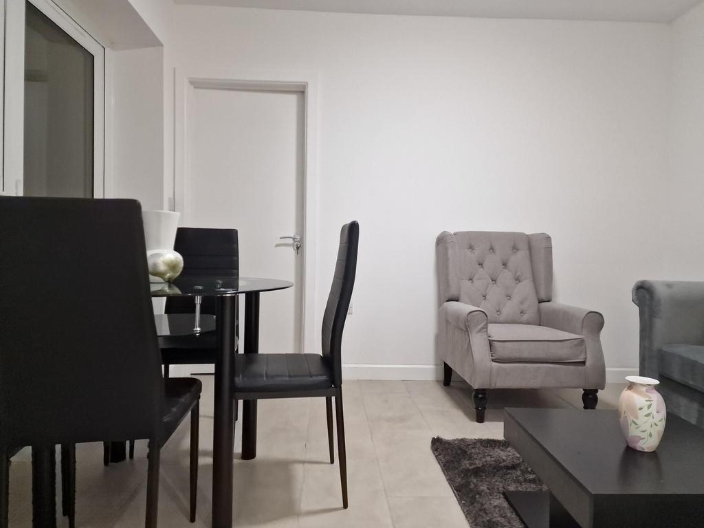 Bright, modern living area with a glass dining ...