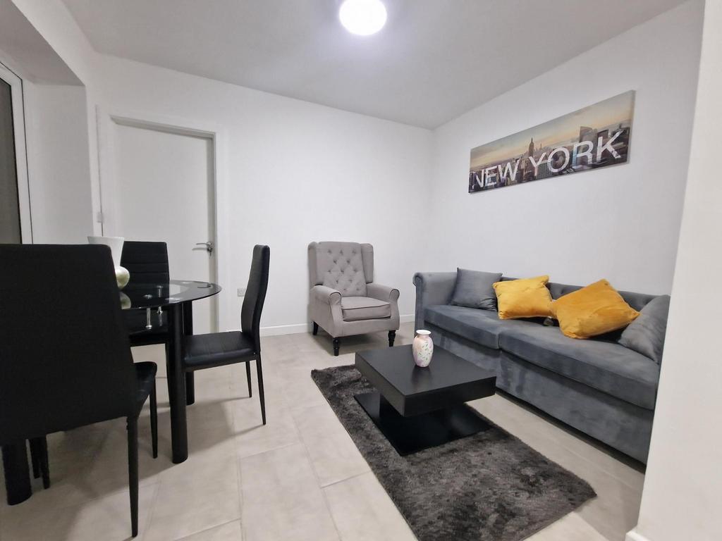 Bright, modern living room with a comfortable g...