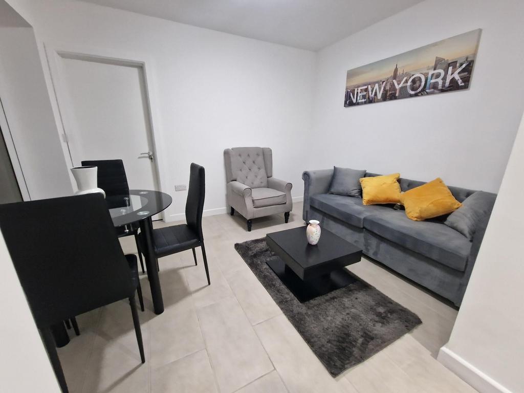 Bright, modern living room with a comfortable g...