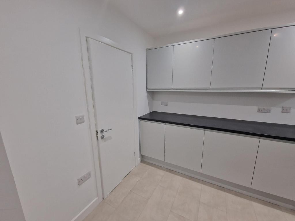Modern, minimalist kitchen with sleek handleles...