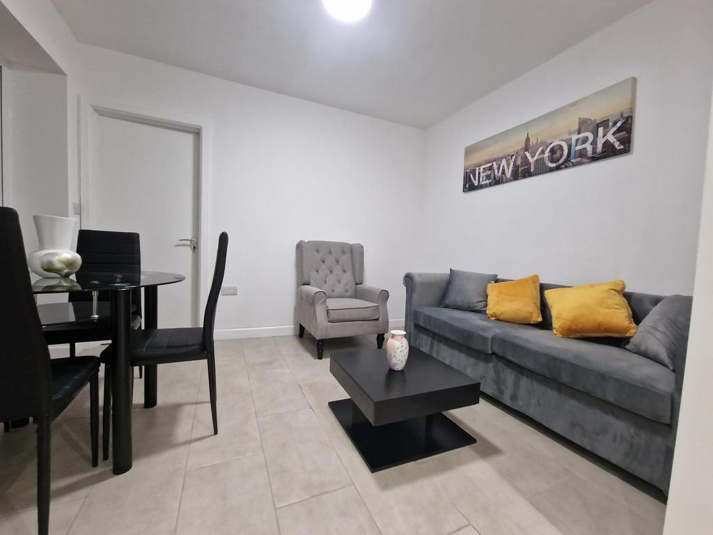 Bright, modern living room with a comfortable g...