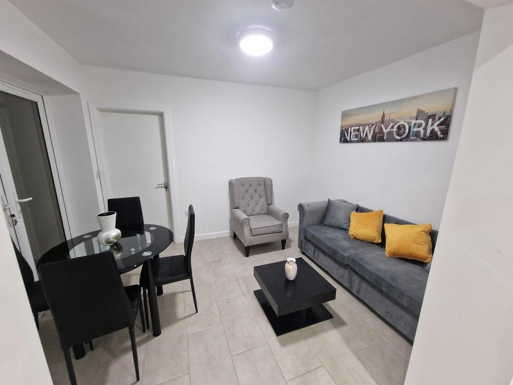 Bright, modern living room with a comfortable g...