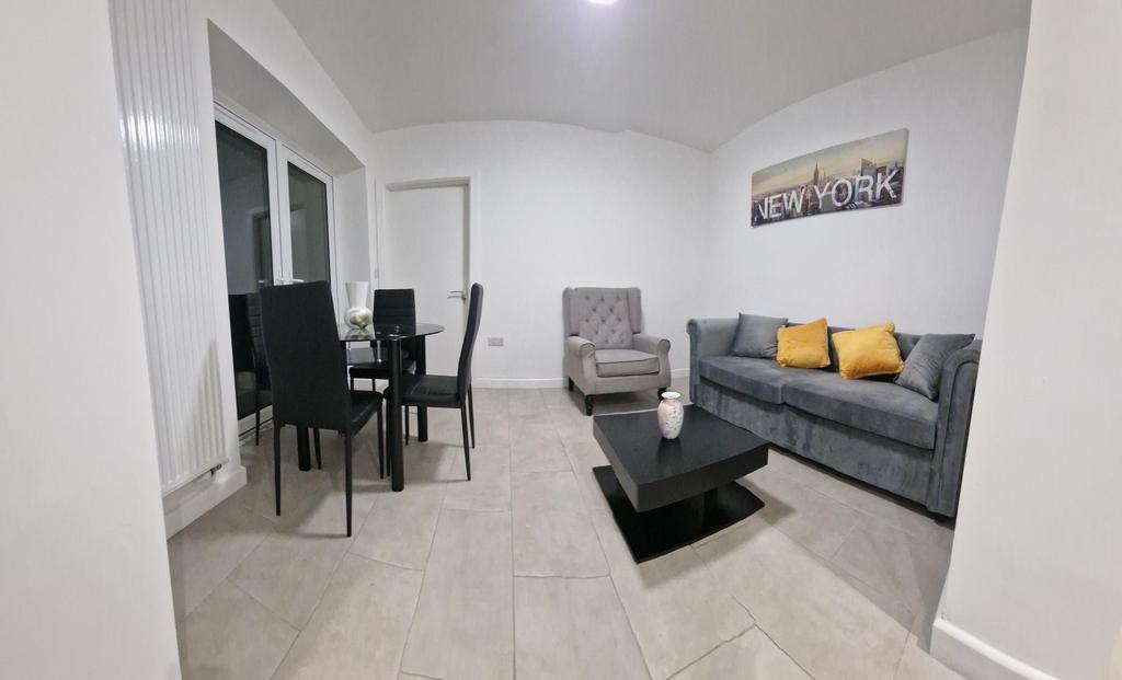 Bright, modern living room with a grey sofa acc...