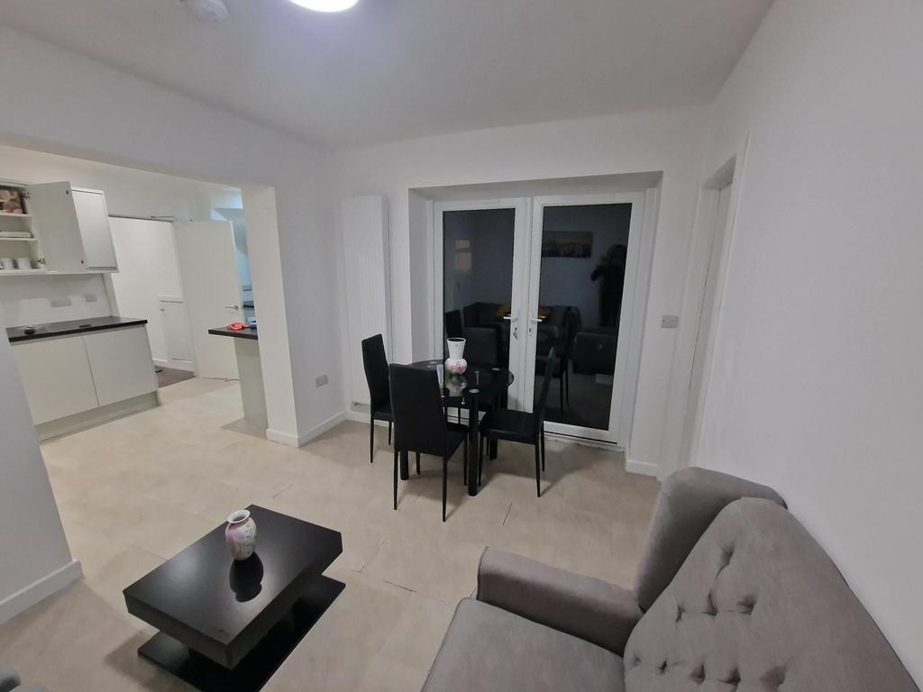 Bright, modern open-plan living area with a com...
